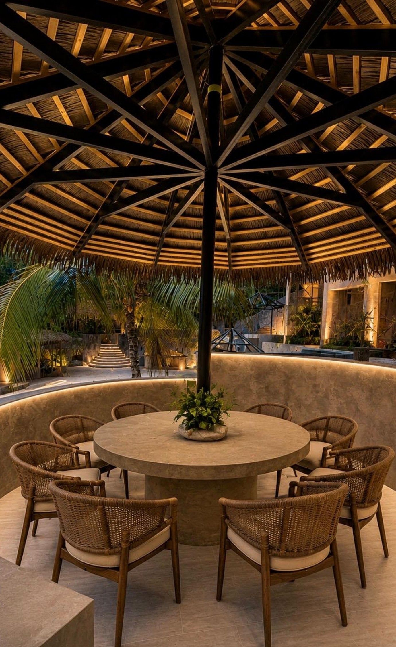 Thatched dining pavilion lit at dusk