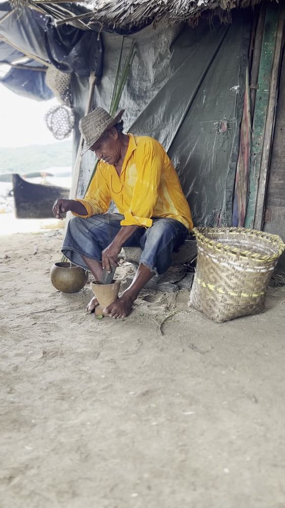 A local artisan grinding cacao by hand
